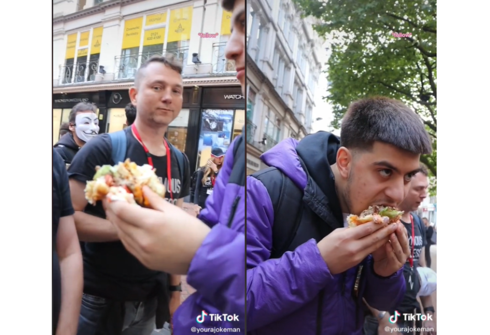 Tiktoker mangia per sfida un hamburger gigante davanti a una folla di manifestanti vegani