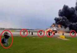 Aereo in fiamme, polemica per i sopravvissuti che scappano con la valigia