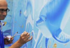 Artista trasforma le pareti grigie degli ospedali in coloratissimi paesaggi marini